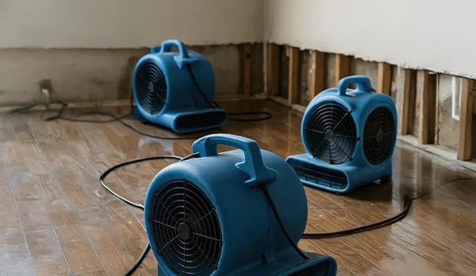 Air movers drying a floor after a water loss